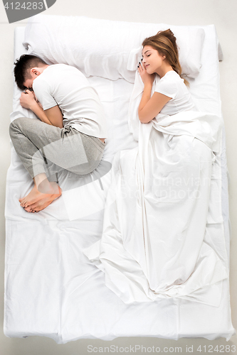 Image of The young lovely couple lying in a bed