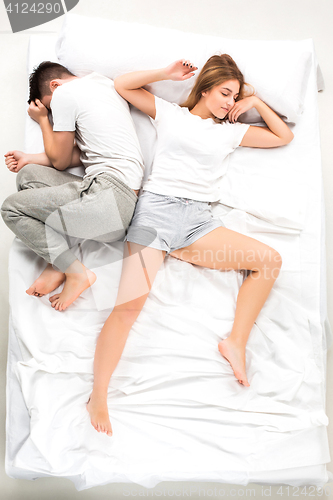 Image of The young lovely couple lying in a bed