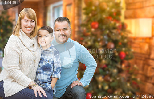Image of Young Mixed Race Family In Front of Christmas Tree