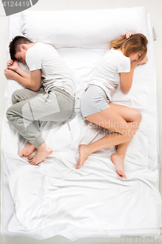 Image of The young lovely couple lying in a bed