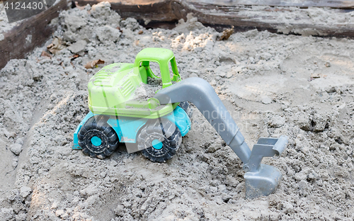 Image of Toy trucks on sand