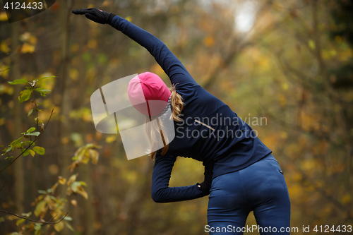 Image of Young girl in autumn park
