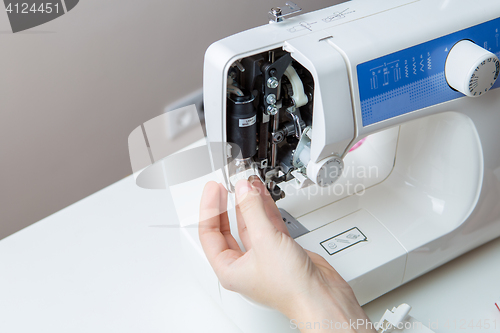 Image of Young man repairing sewing machine