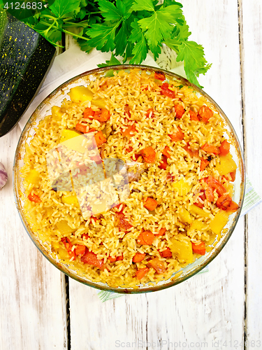 Image of Rice with chicken and zucchini in pan on board top