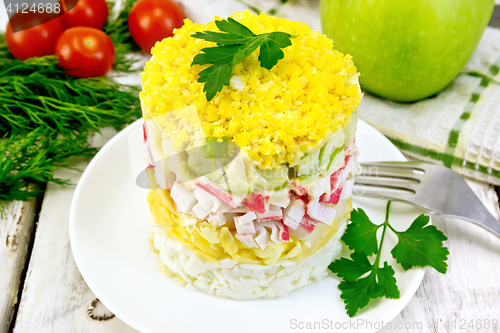 Image of Salad of crab sticks and apple on board
