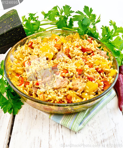 Image of Rice with chicken and zucchini in glass pan on board