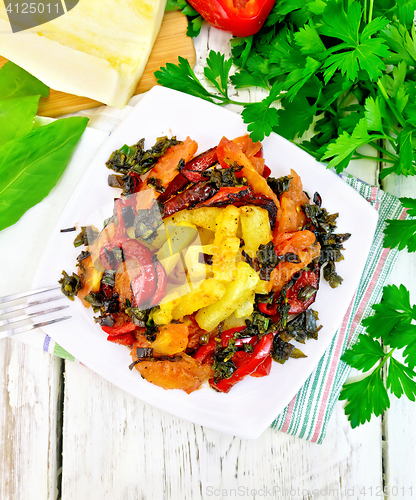 Image of Courgettes with vegetables in plate on board top