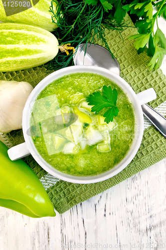 Image of Soup cucumber with peppers in white bowl on light board top