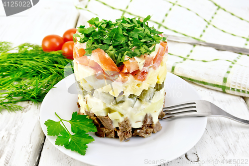 Image of Salad with beef and tomato on light board