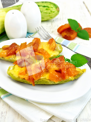 Image of Courgettes in spicy sauce with apricots and cheese on board