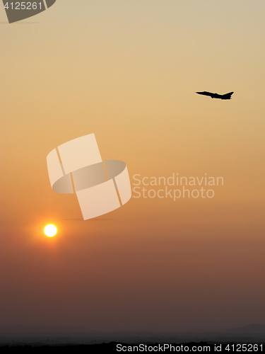 Image of Airplane in the sky at sunrise