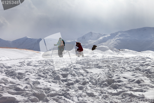 Image of Father and daughter on ski resort after snowfall at sun day with