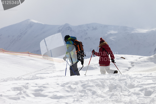 Image of Father and daughter on ski resort after snowfall