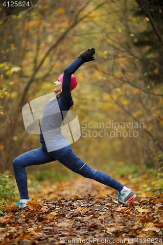 Image of Young woman on stretching exercises