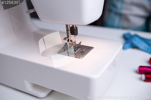 Image of Sewing-machine on table with coils