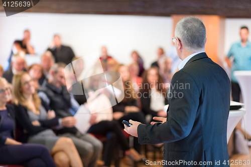 Image of Speaker at Business Conference and Presentation.