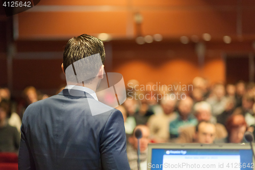 Image of Public speaker giving talk at Business Event.