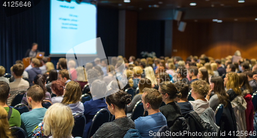 Image of Audience in lecture hall participating at business event.