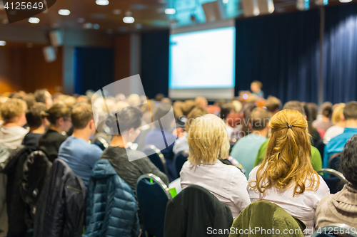 Image of Audience in lecture hall participating at business event.