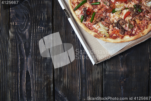 Image of Pizza on a wooden table