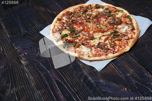 Image of Homemade pizza on a wooden table