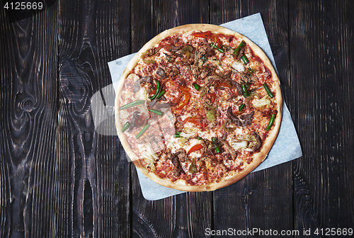 Image of Homemade pizza on a wooden table