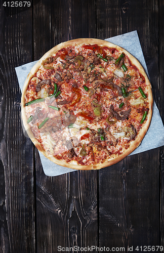 Image of Homemade pizza on a wooden table