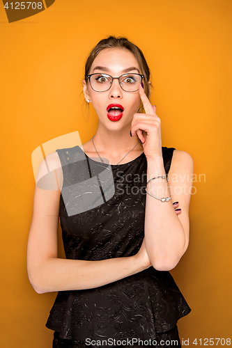 Image of Portrait of young woman with shocked facial expression