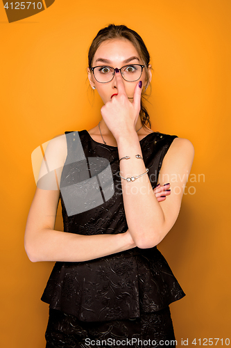 Image of Portrait of young woman with shocked facial expression