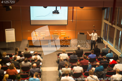 Image of Business speaker giving a talk in conference hall.