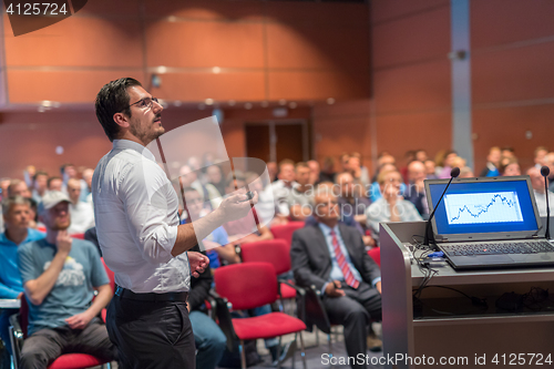 Image of Public speaker giving talk at Business Event.