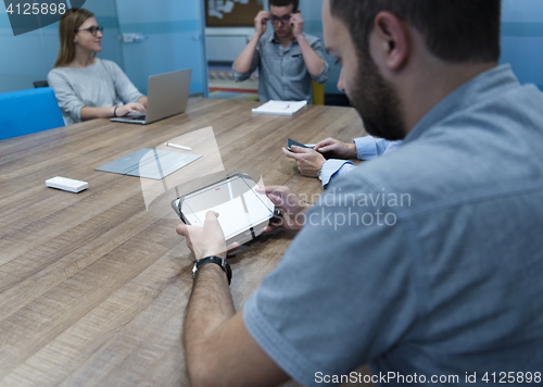 Image of close up of businessman on meeting using tablet