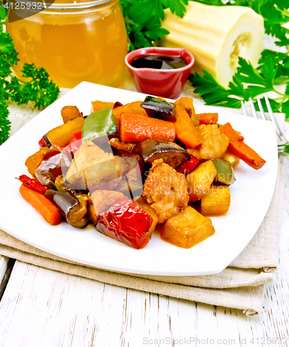 Image of Roast with vegetables and honey in plate on board