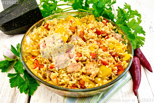 Image of Rice with chicken and zucchini in glass pan on light board