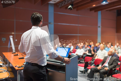 Image of Public speaker giving talk at Business Event.