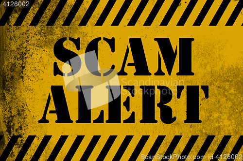 Image of Scam alert  sign yellow with stripes