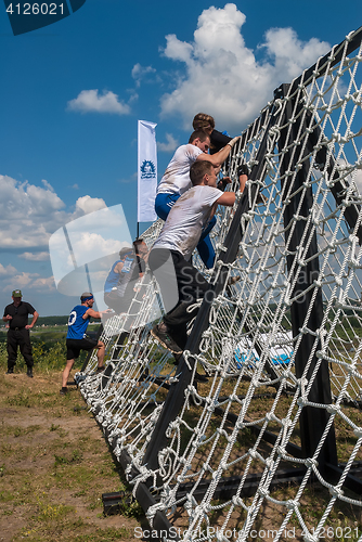 Image of Team storms net wall in extrim race. Tyumen.Russia