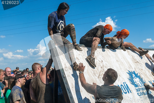 Image of Athletes storm wall in extrim race. Tyumen.Russia