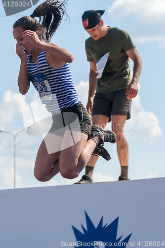 Image of Pretty girl jumps in water in extrim racing