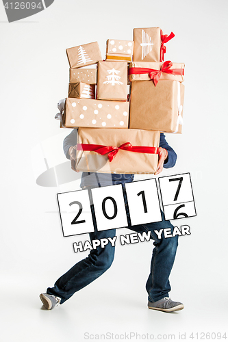 Image of Gift boxes in the hands of young man