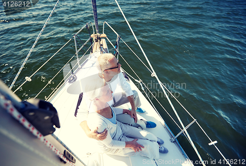 Image of senior couple hugging on sail boat or yacht in sea