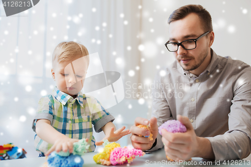 Image of father and son playing with ball clay at home