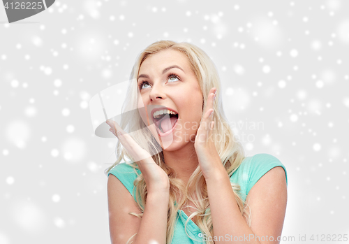 Image of surprised smiling young woman or teenage girl