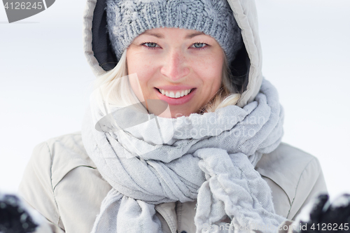 Image of Girl  playing with snow in winter.