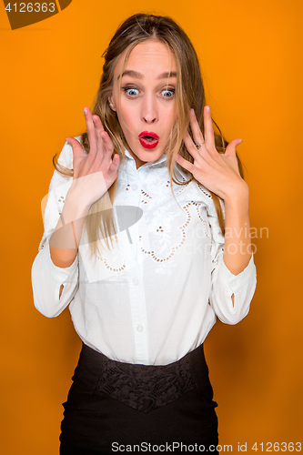 Image of Portrait of young woman with shocked facial expression