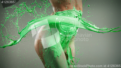 Image of The beautiful woman with green liquid paint over her body