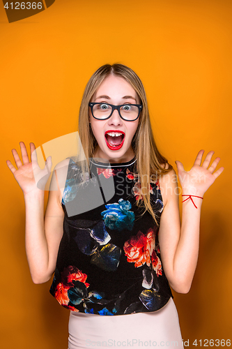 Image of Portrait of young woman with shocked facial expression