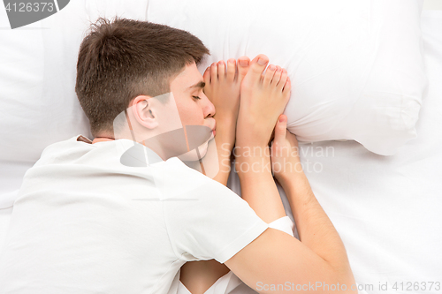 Image of The young lovely couple lying in a bed