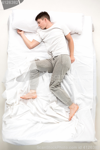 Image of The young man lying in a bed