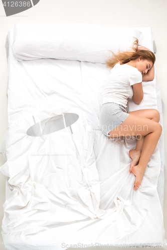 Image of The young woman lying in a bed